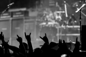 Bunch of fans happy during a concert throwing up the devil horns